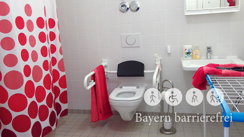 Behindertengerechtes Bad mit Accessoires in kräftigem, freundlichem Rot.